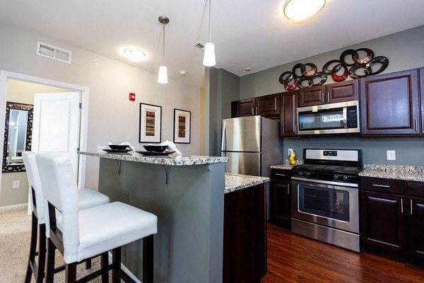 A kitchen with a white chair and a counter.,A kitchen with a white chair and a counter.